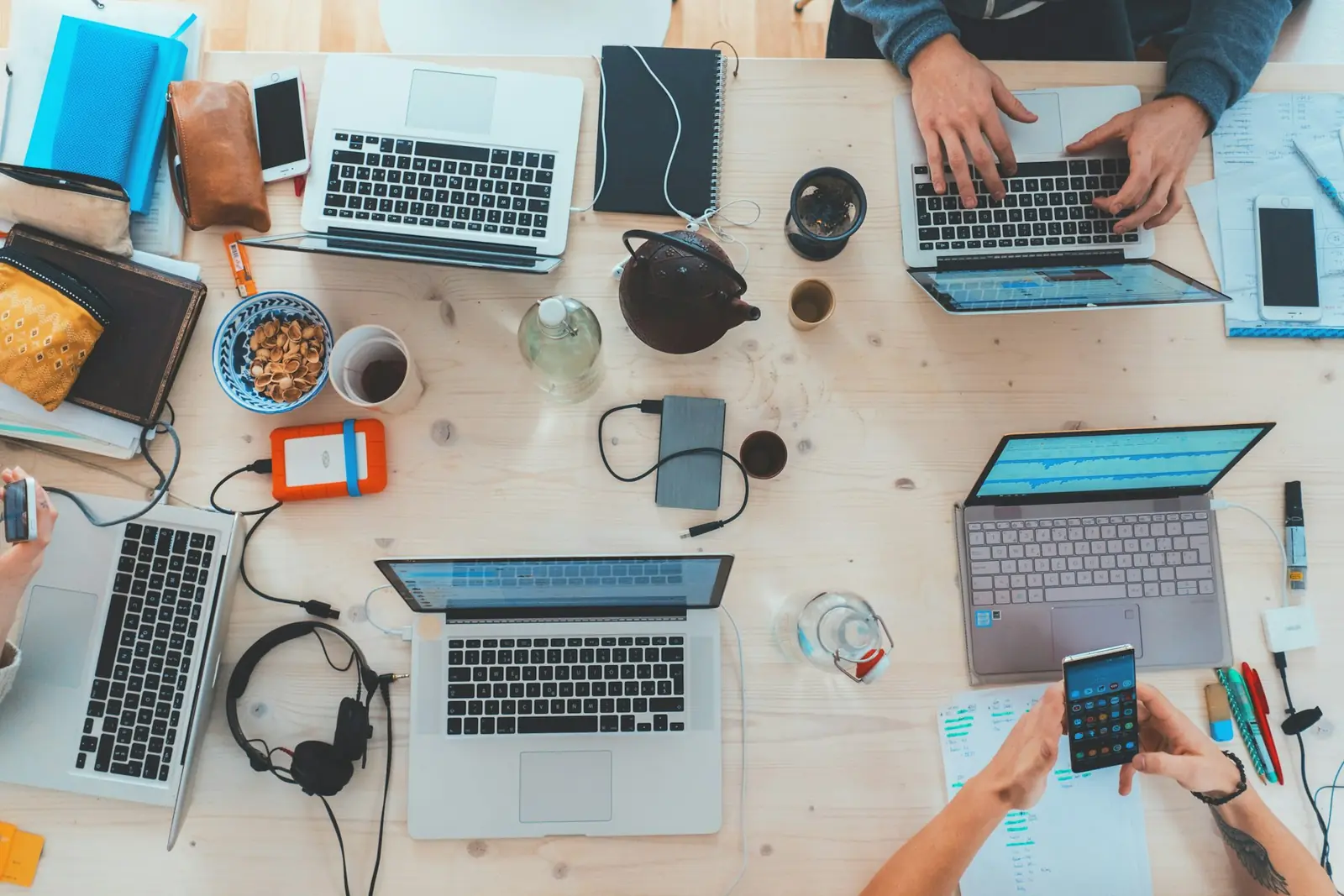 Workspace peripherals, keyboards and connected devices arranged on a desk