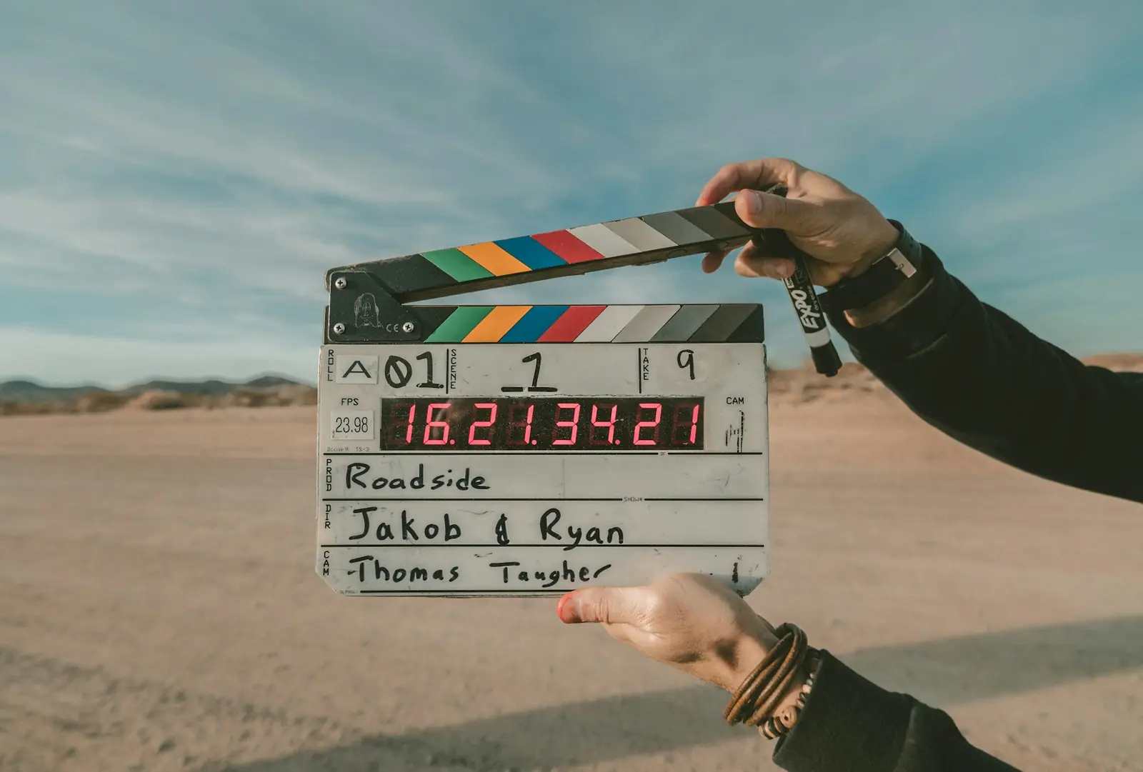 Production clapperboard held on location during an advertising shoot