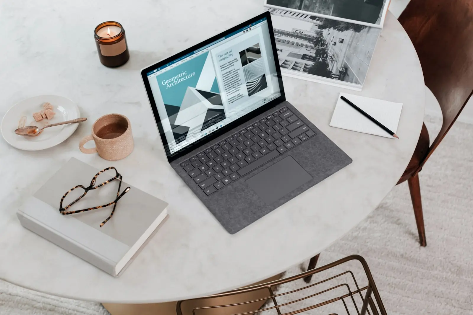 Laptop showing a self-service portal interface on a workspace table