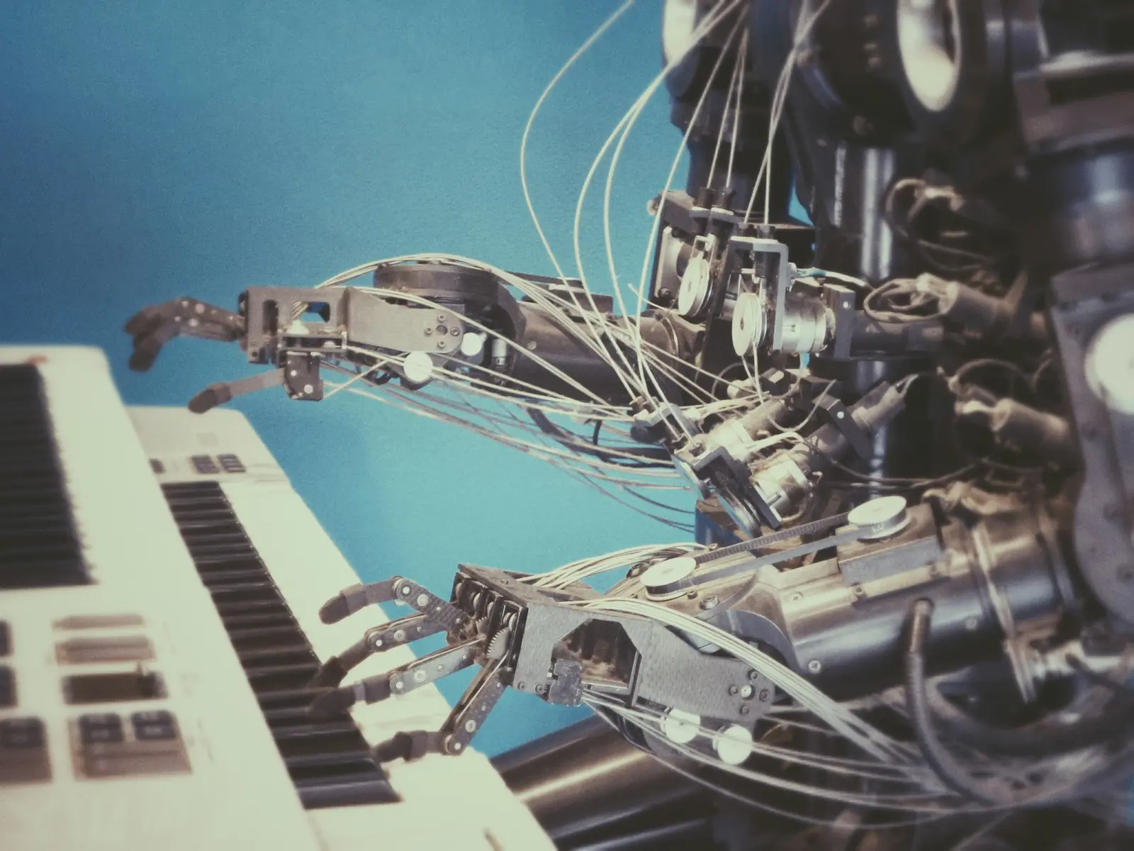 Robotic hand operating a keyboard, representing automated conversation handling